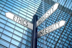 Ethics concept - crossroads sign, office building.